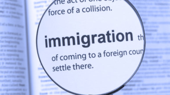 Immigration highlighted thru a magnifying glass 