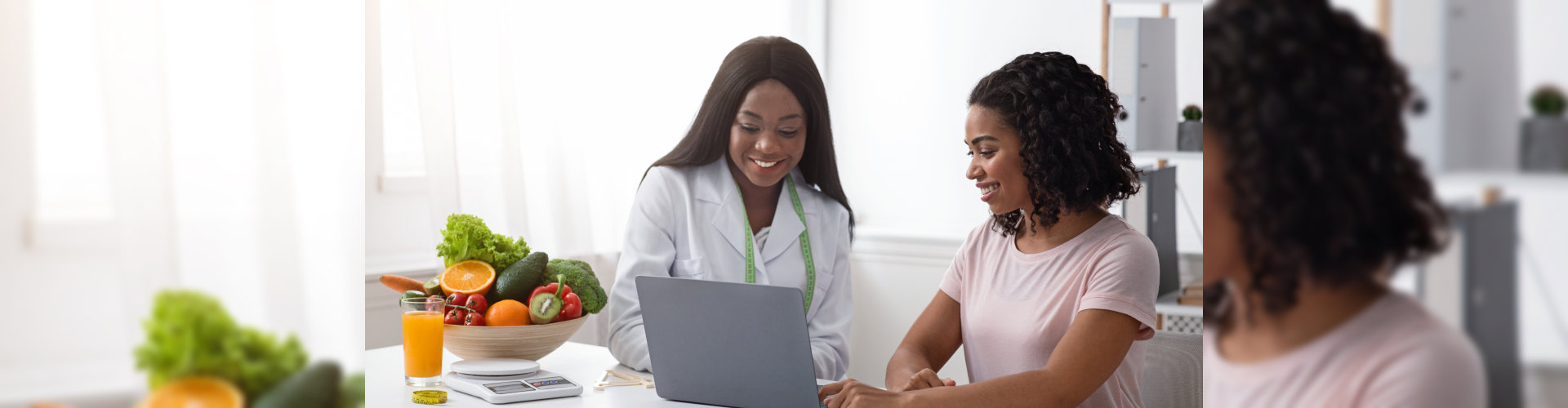 women nutritionist and patient looking at laptop screen